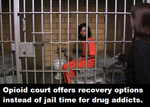 Female prisoner shackled in her small cell